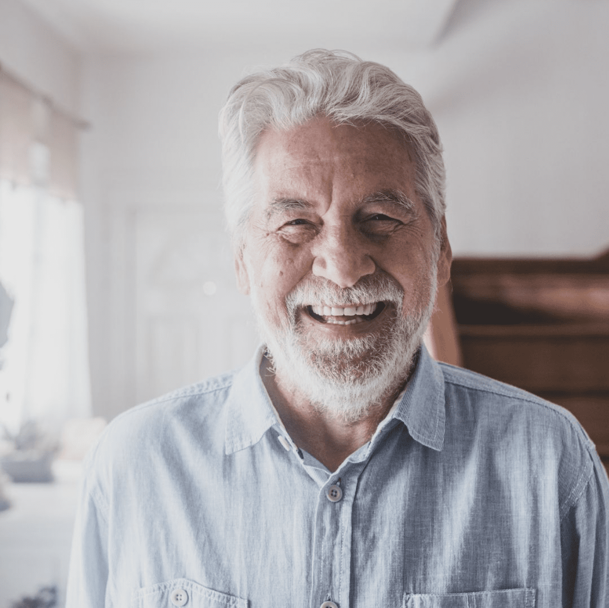 Elderly man smiling after dental crown procedure