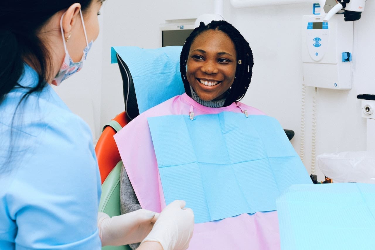 Girl smiling at dental office preparing for dental implant