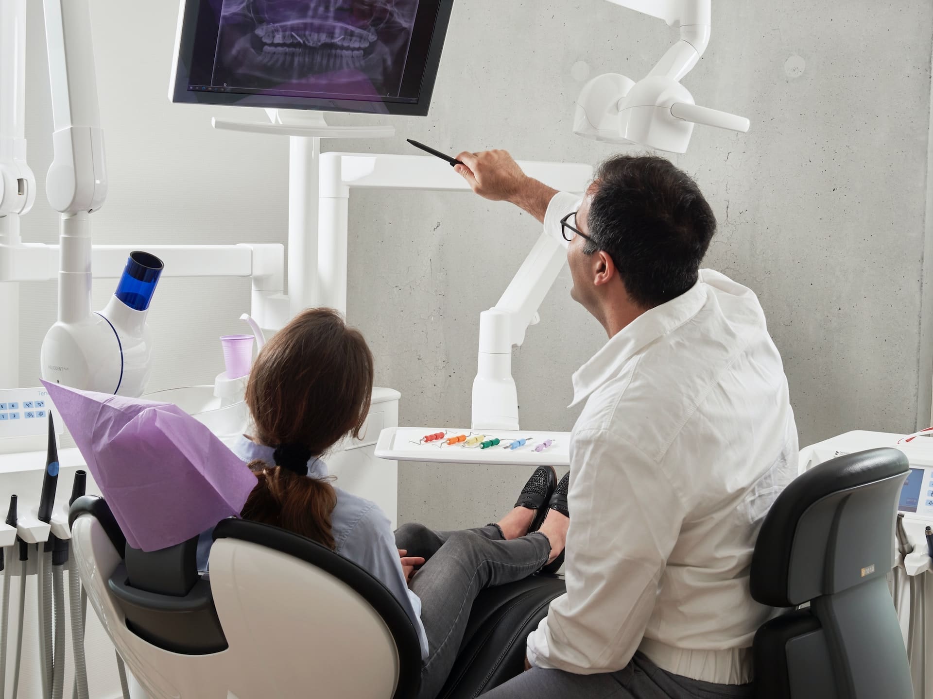 Dentist explaining dental X-ray to patient